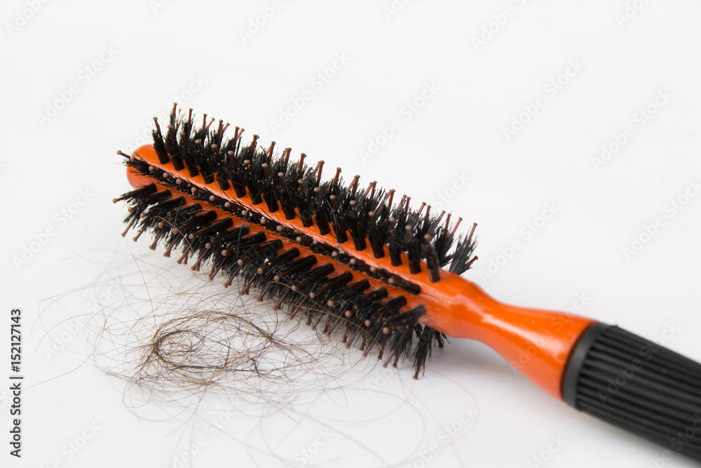 Black comb with hair loss isolated on white background Black comb with hair loss isolated on white background