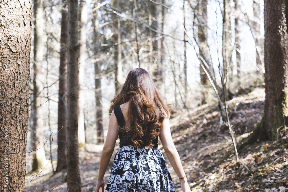 Portrait of woman with beautiful long hair walking in a forest on a sunny day Portrait of woman with beautiful long hair walking in a forest on a sunny day