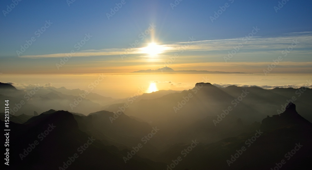 Sunset panoramic from summit of Gran canaria, Roque Bentayga and Tenerife island in background, Canary islands