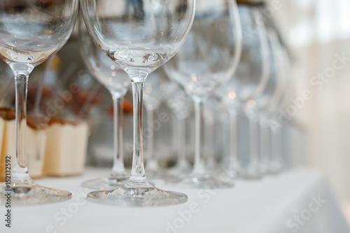 Close up picture of empty glasses on the beige tablecloth  in restaurant