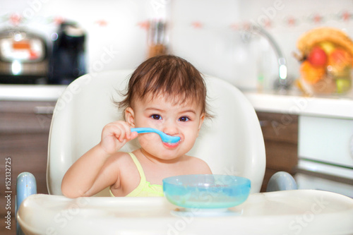 baby eating in the kitchen