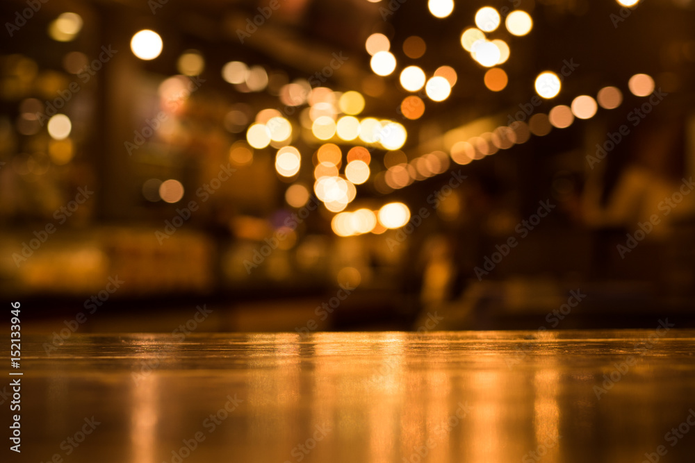 Wood table top with reflect on blur of lighting in cafe,restaurant background/selective focus. - obrazy, fototapety, plakaty 