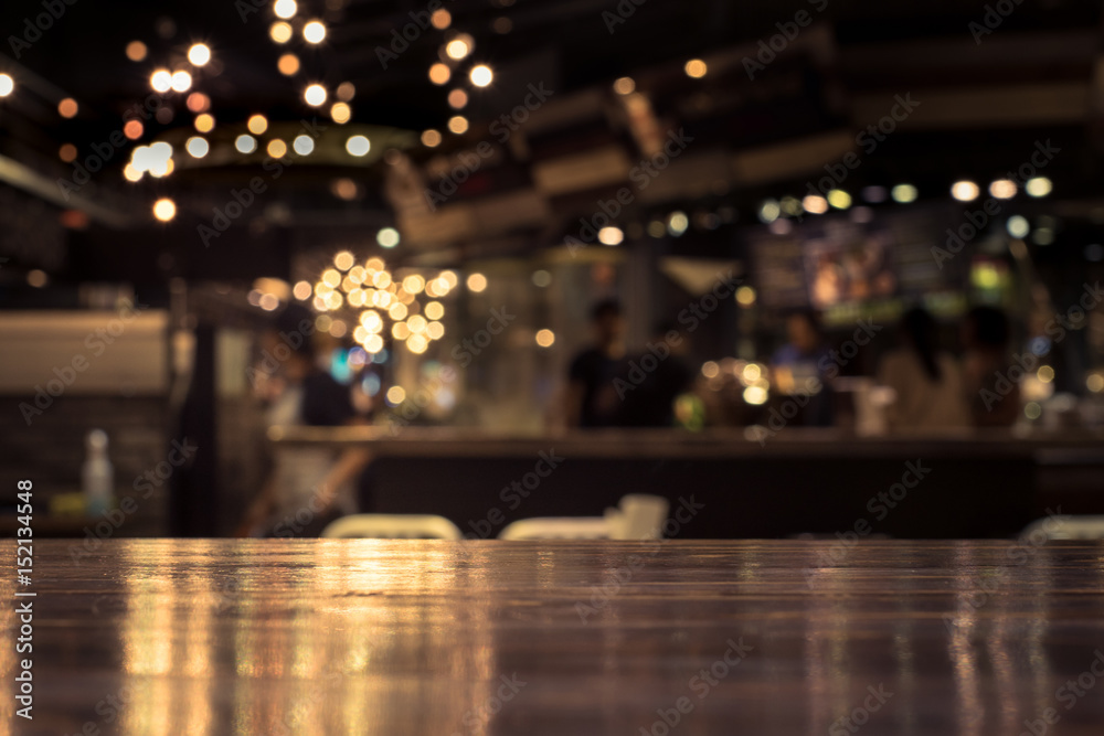 Wood table top with reflect on blur of lighting in cafe,restaurant background/selective focus. - obrazy, fototapety, plakaty 