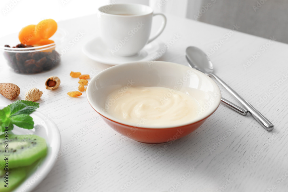 Composition with tasty yogurt on kitchen table Composition with tasty yogurt on kitchen table