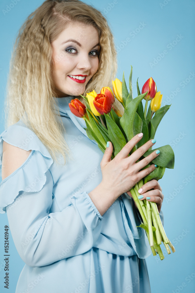 Woman holding bouquet of tulips flowers Woman holding bouquet of tulips flowers