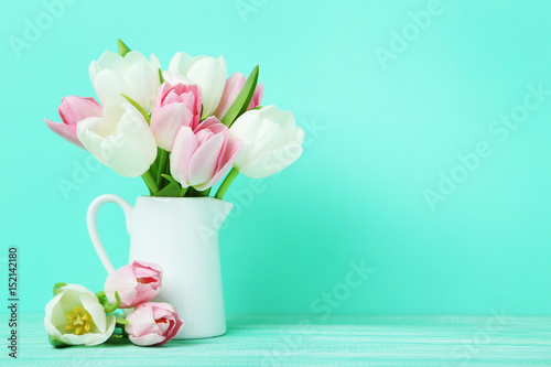 Fototapeta Naklejka Na Ścianę i Meble -  Bouquet of tulips in jug on green background