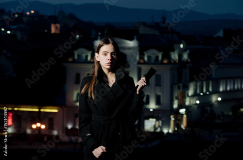 woman in light of street lamps, girl at night city