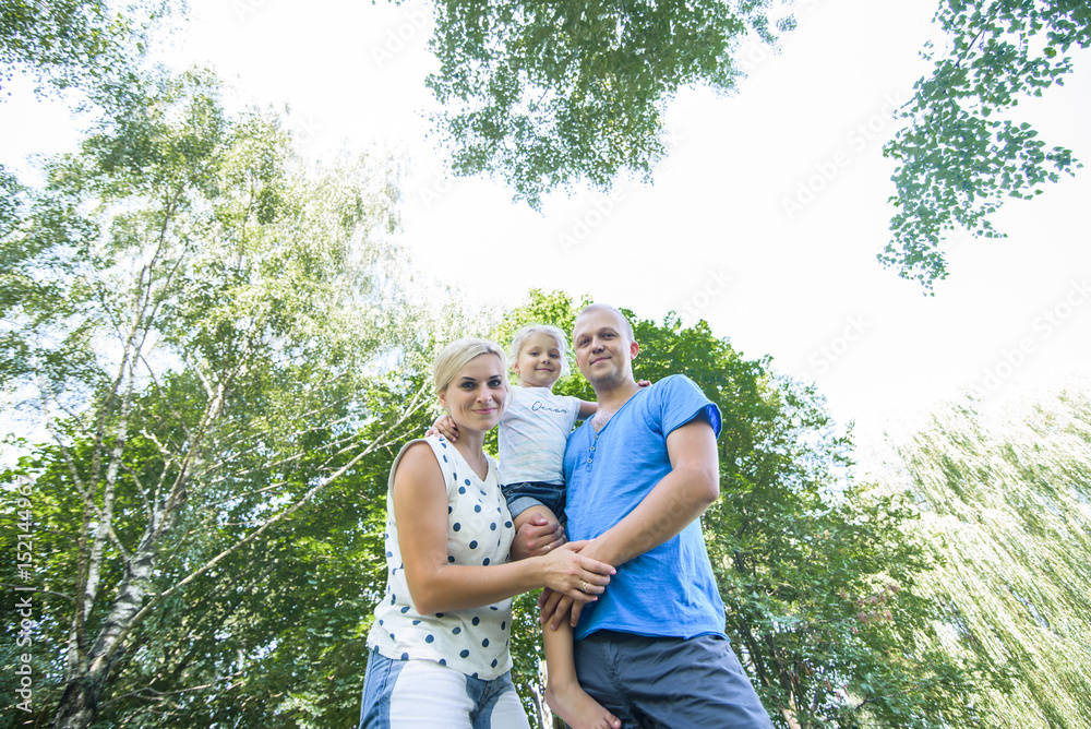 Happy young family spending time together outside in green nature. Happy young family spending time together outside in green nature.