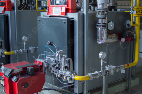 Modern high power industrial gas boilers with natural gas burners in the gas boiler plant photo