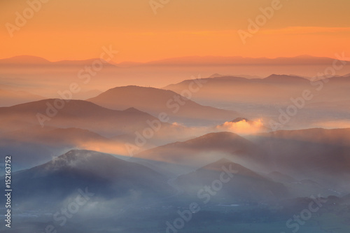 Beautiful sunrise over cloudy mountains