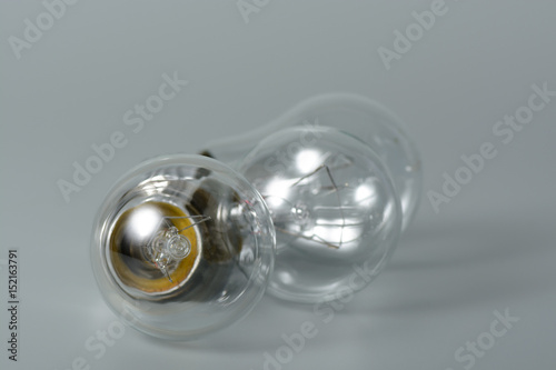 Three incandescent bulbs on grey background