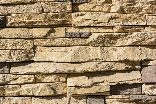 Flat rocks layered to form a solid wall photo