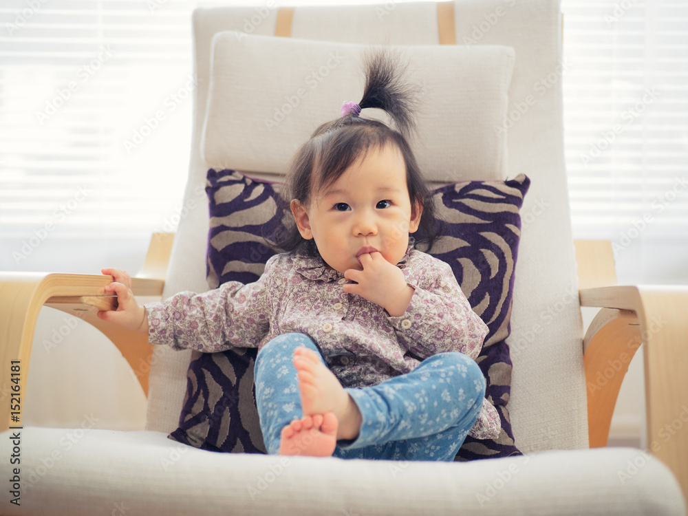 cute baby girl sitting on rocking chair cute baby girl sitting on rocking chair