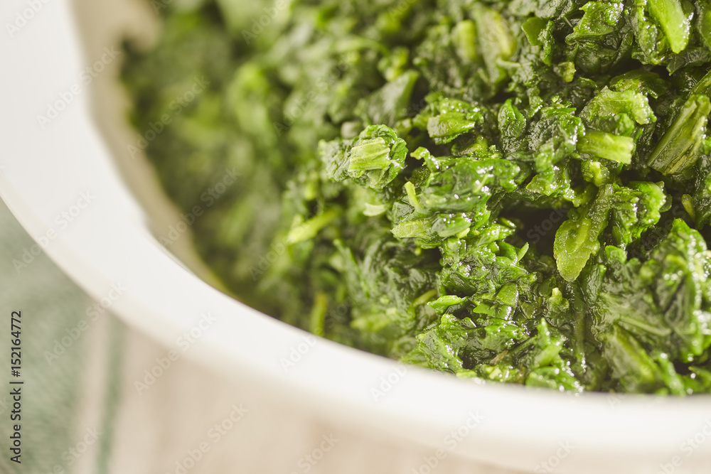 a bowl of cooked spinach a bowl of cooked spinach