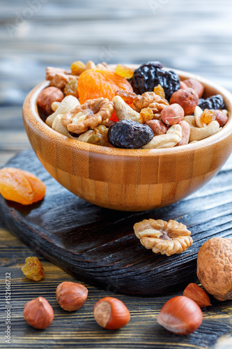 Dried fruit and mixed nuts in a wooden bowl.