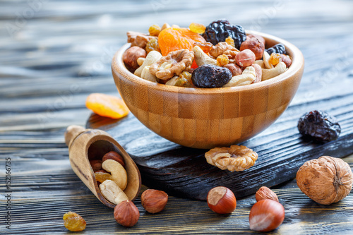 Fototapeta Naklejka Na Ścianę i Meble -  Dried fruits and nuts mixed in wooden bowl.