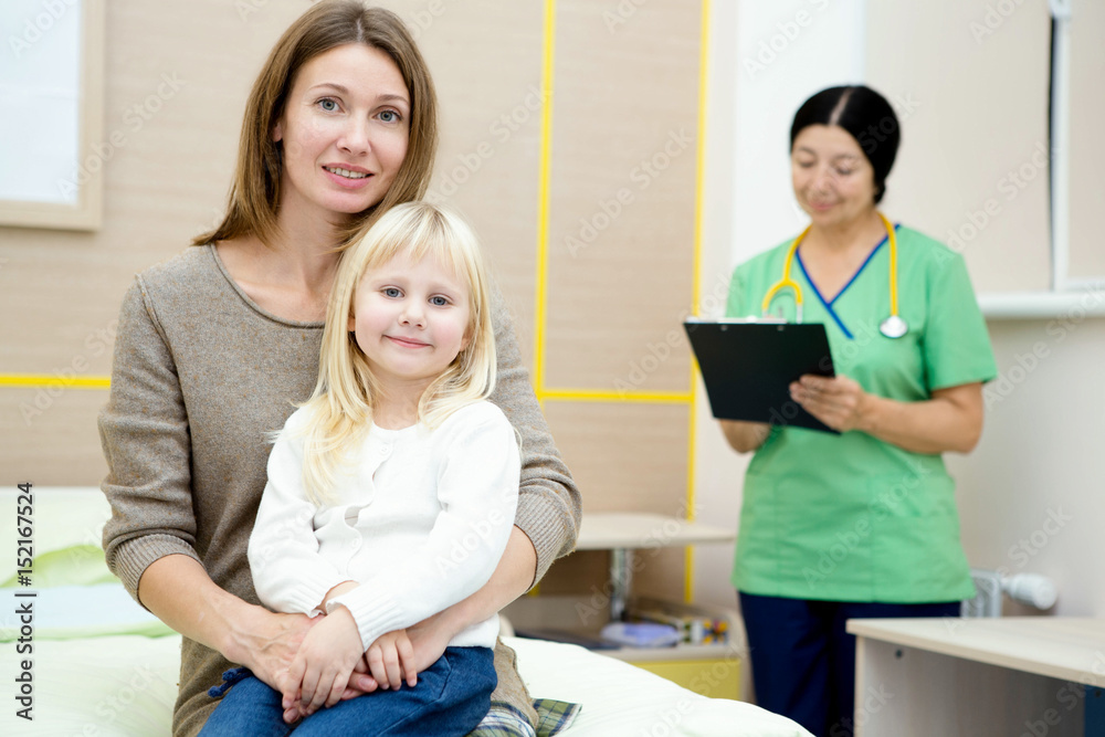 Beautiful mature woman and her little daughter at the hospital Beautiful mature woman and her little daughter at the hospital