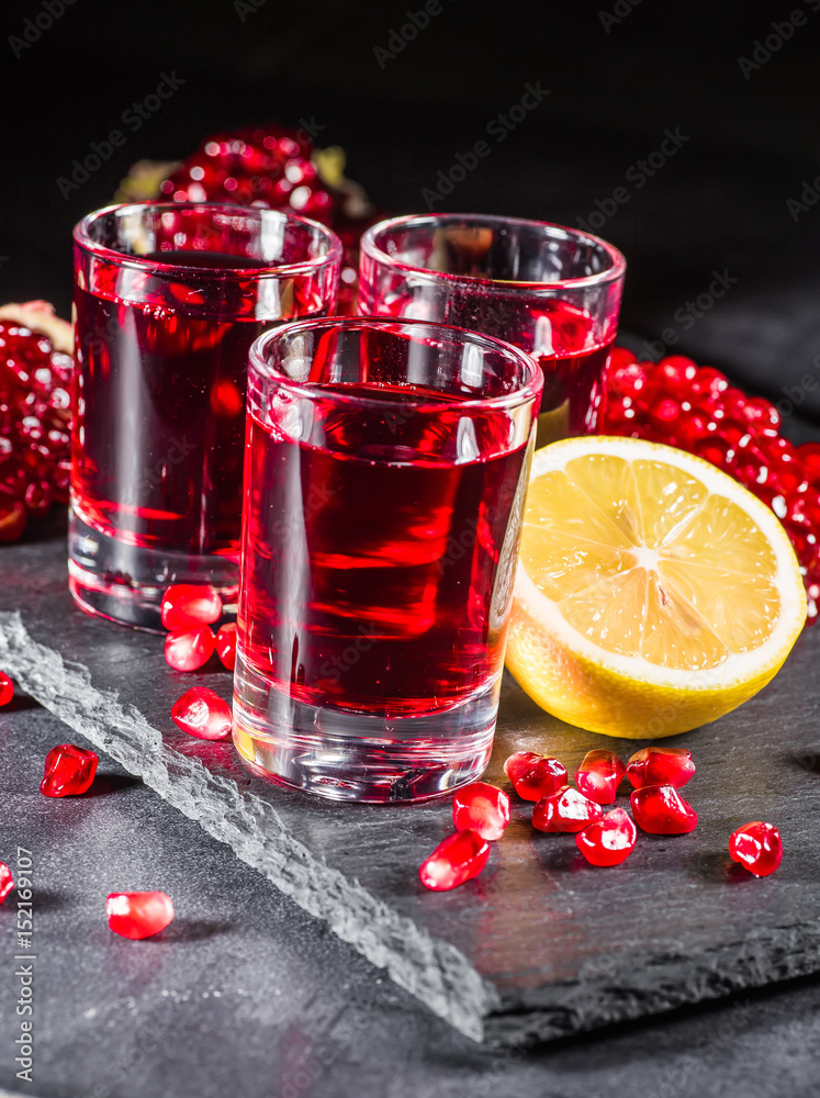 Fresh red juice cocktail with pomegranate seeds and ice Fresh red juice cocktail with pomegranate seeds and ice