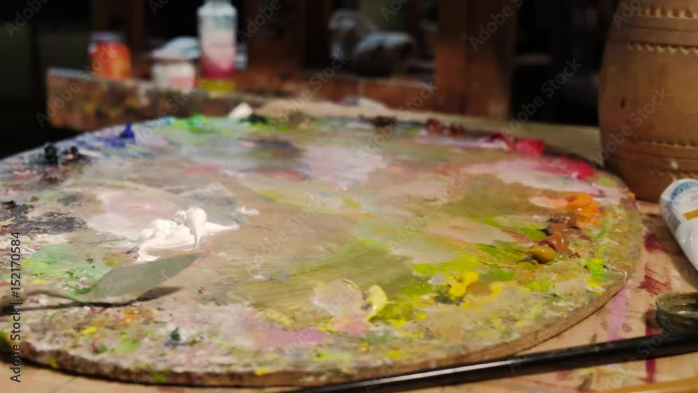 An elderly artist writes a picture in his studio 4k An elderly artist writes a picture in his studio 4k
