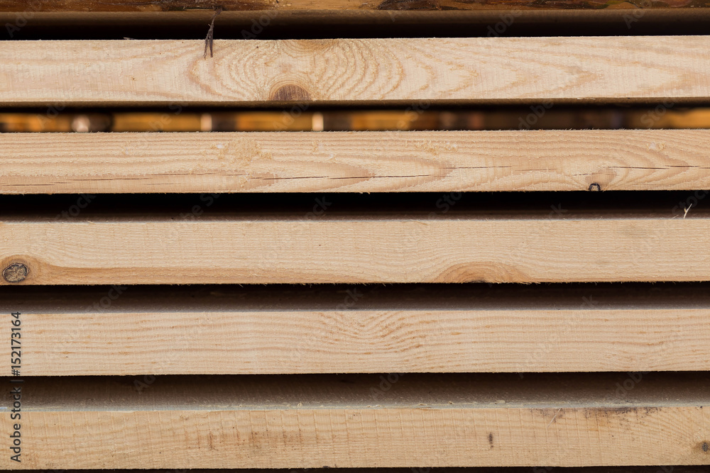 parallel rows, piles of boards, wood, pine. needles, close-up, horizontal, material, sawmill, workshop, plant, work.