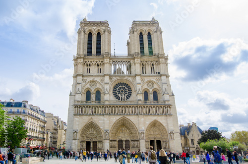 Notre-Dame Roman Catholic Cathedral front facade in Paris, a wonderful gothic churchwith a lot of people visiting it