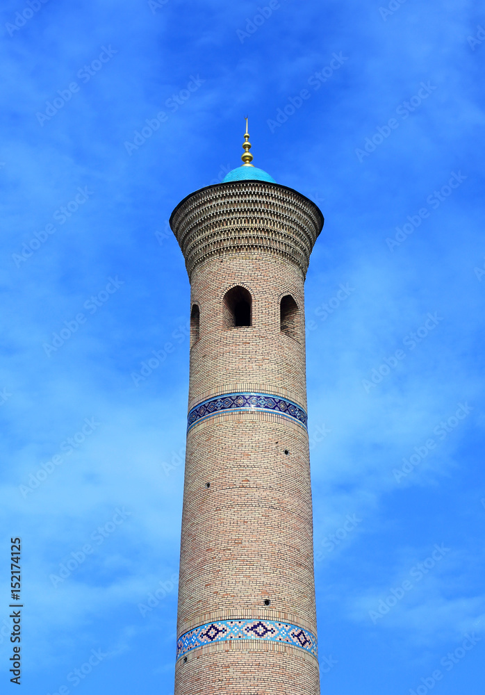 Minaret on the background of a cloudy sky