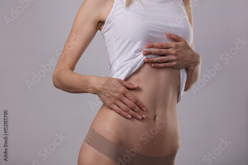 Healthy attractive woman body  waistline. Slim female torso  waist   abdomen close up. Sport  fitness  Dieting results laser lipolysis  active lifestyle concept
