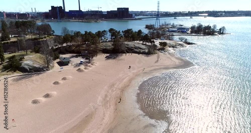 Hietaranta beach, Cinema 4k aerial of people on hietaniemen uimaranta, on a sunny spring day, in Helsinki, Finland photo