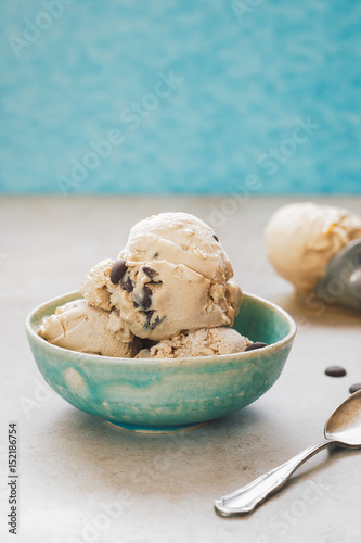 Ice cream in a bowl. Homemade ice cream with chocolate chip cookies. Selective focus, vintage toned image, blank space