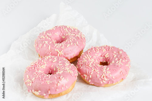 Pink donuts with sprincles on white