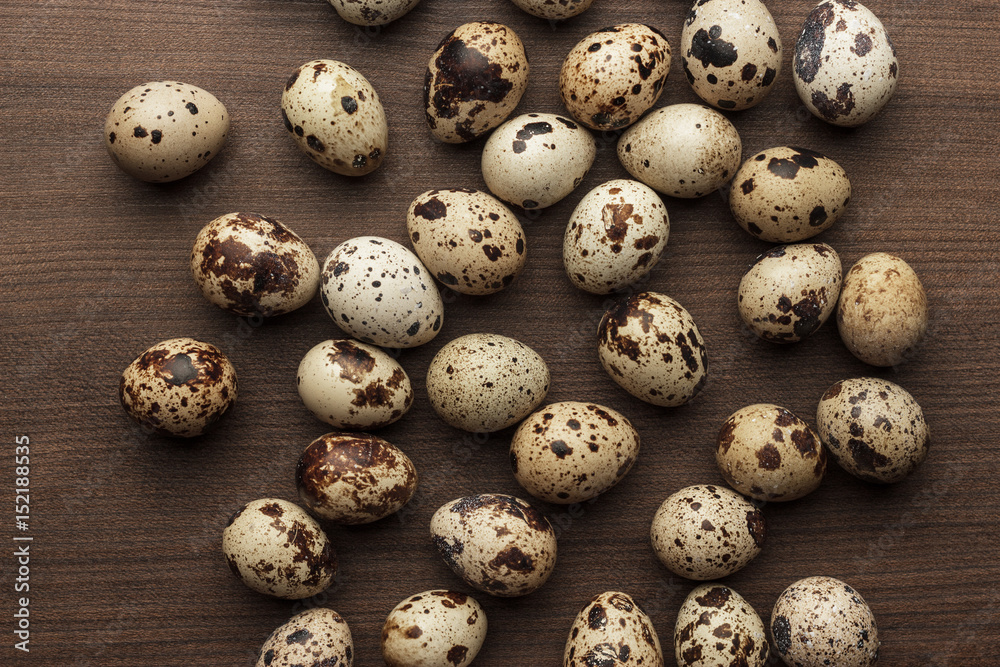 some quail eggs on the brown wooden table
