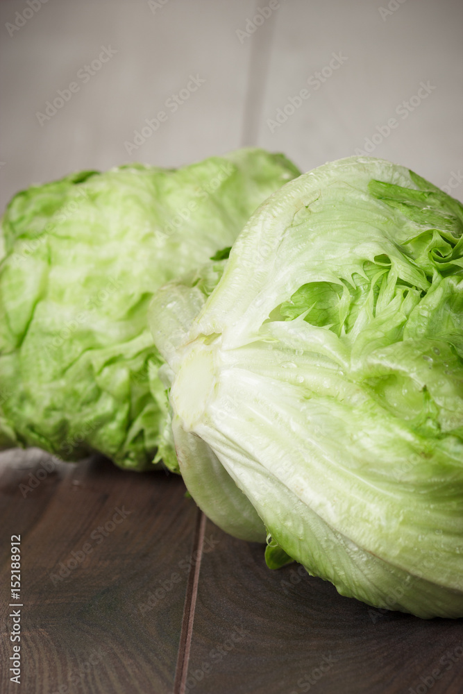 fresh green iceberg salad on wooden table fresh green iceberg salad on wooden table
