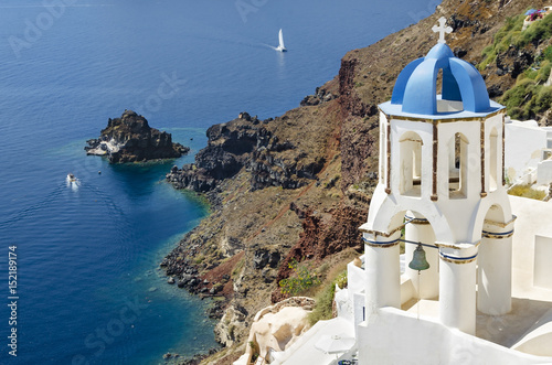 Santorini classic view with white belfry - Oia village in Greece