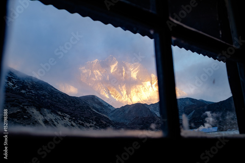 Sunset over south face of Lhotse visible from window, in Himalaya, Nepal photo