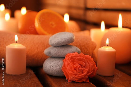 Beautiful spa setting with candles on wooden background