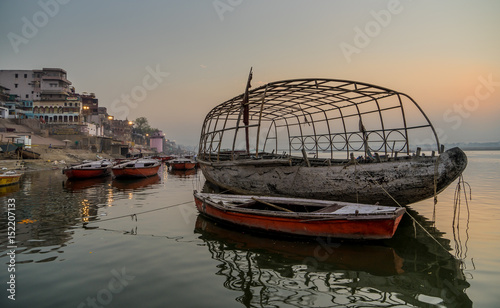 An Old boat floting on the Ganges River in the morning photo