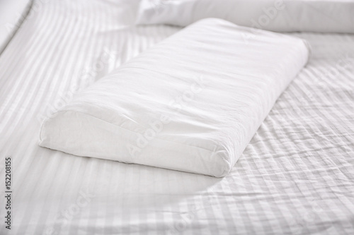 Fototapeta Naklejka Na Ścianę i Meble -  White orthopedic pillow on bed