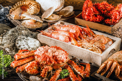 Seafood cuisine plate as an ocean gourmet dinner background. Crab, seashells, oysters, shrimp and other seafood delicacies.
