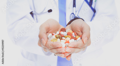 Doctor holding heap of drugs in a hand