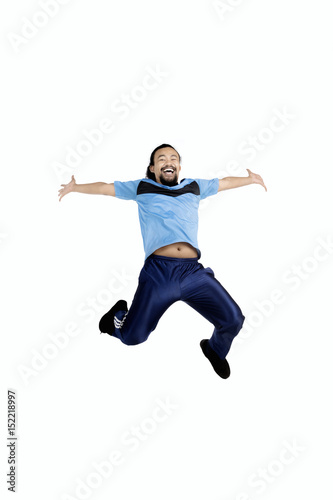 Young man leaping in studio