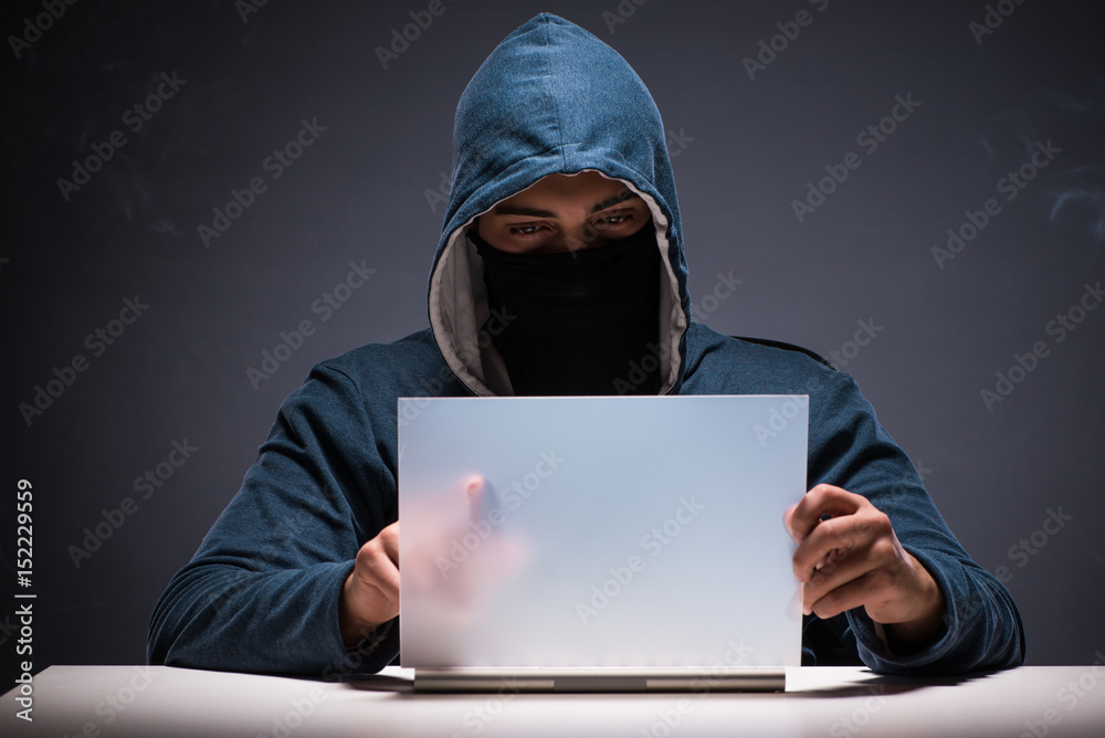 Computer hacker working in dark room Computer hacker working in dark room