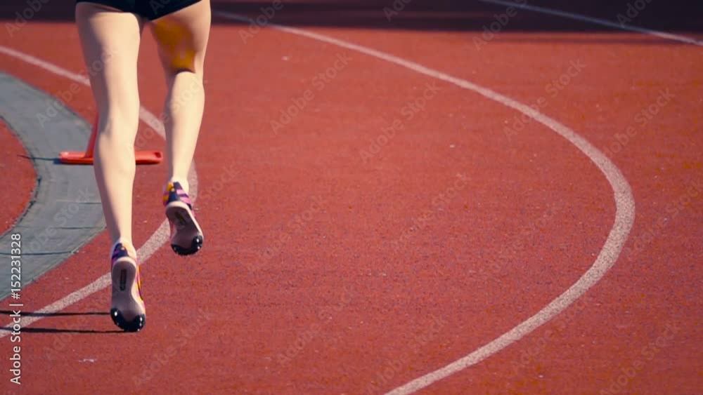 Girl in short shorts running sprint on the stadium, slow motion Girl in short shorts running sprint on the stadium, slow motion