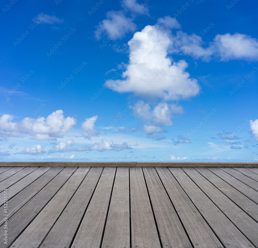 wooden floor with blue sky background