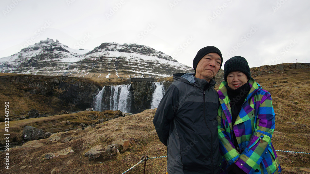 Asian retired senior travel around the world to Iceland. Happy together at Kirkjufell mountain