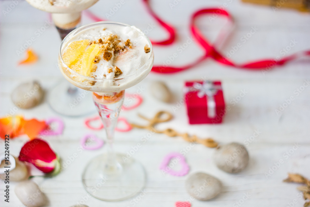 Ice cream dessert on table with hearts, ribbons and cloves. Ice cream dessert on table with hearts, ribbons and cloves.