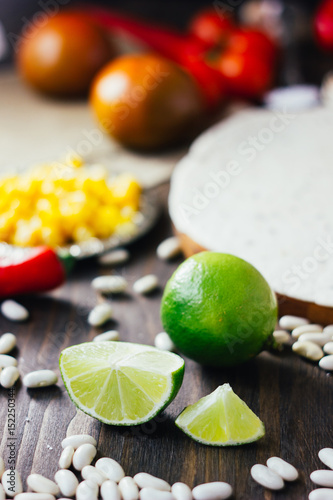 Pieces of green lime on wooden board