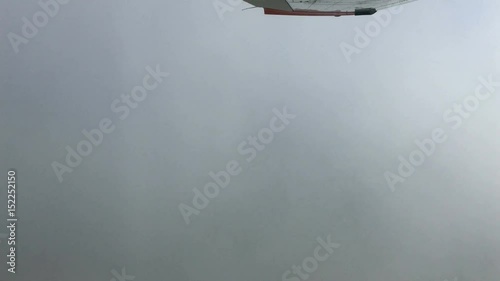 aerial view under wings of  cloud ceiling over tropical landscape 