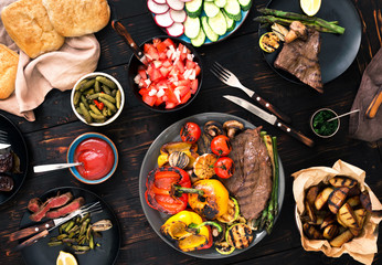 Grill steak and grilled vegetables on the wooden table