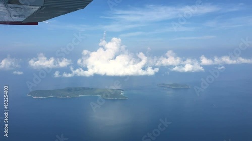 aerial view from aircraft over tropical blue sea with blue sky and cloud at Koh Lan islands, Pattaya