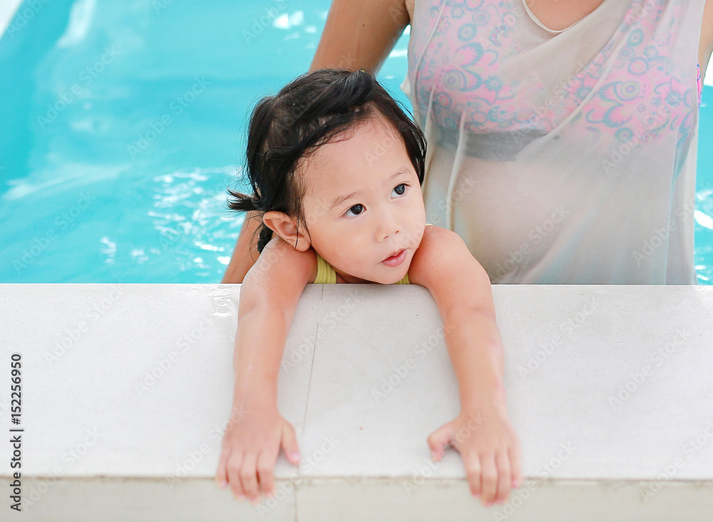 Close up mother teaching kid in swimming pool. Close up mother teaching kid in swimming pool.